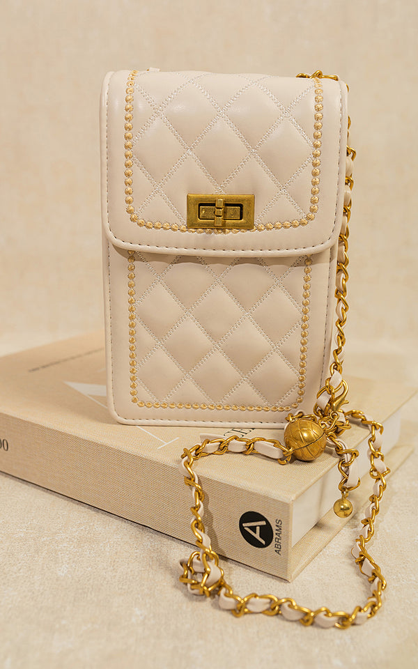 Quilted Crossbody Chain Shoulder Mini Bag on a book, featuring a gold chain strap and secure clasp closure, perfect for fashion-forward individuals.