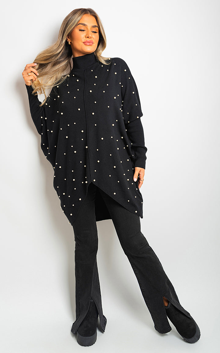 Woman wearing an Ingrid Oversized Pearl Knitted Jumper, showcasing its elegant pearl detailing and relaxed fit, perfect for stylish comfort.