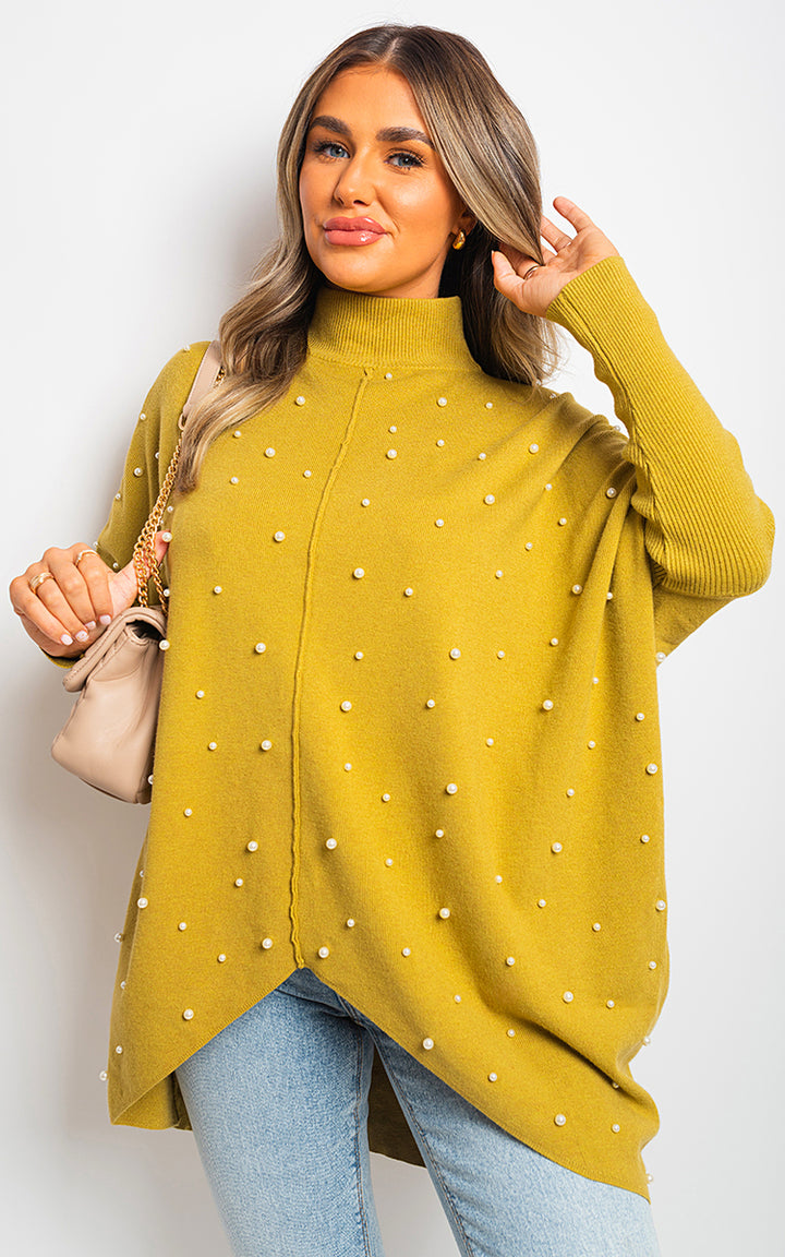 Woman in yellow jumper showcasing the Ingrid Oversized Pearl Knitted Jumper, highlighting pearl detailing and relaxed fit, perfect for stylish comfort.