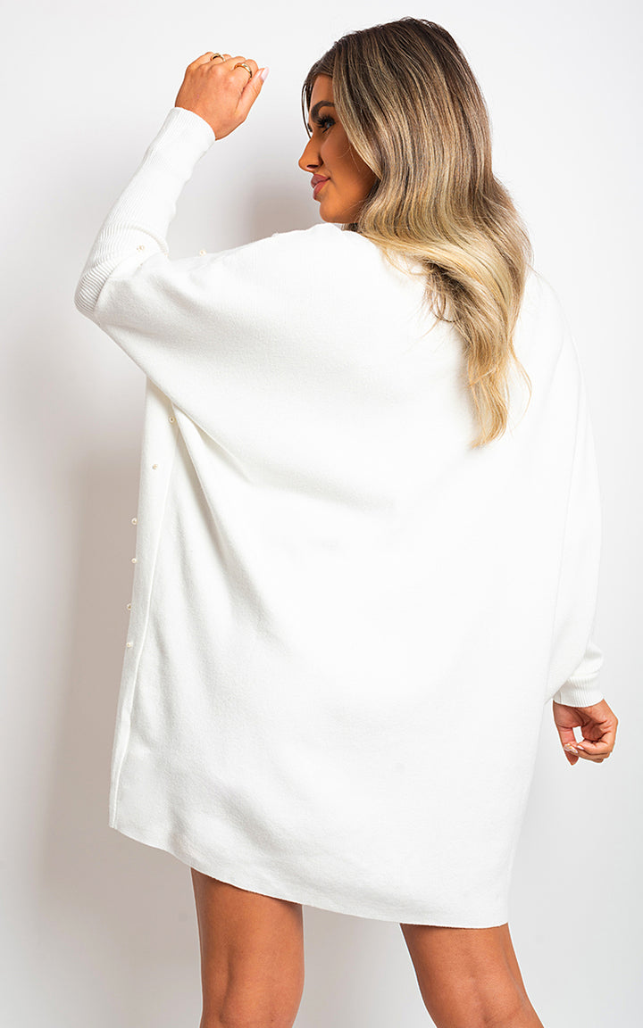 Woman wearing Ingrid Oversized Pearl Knitted Jumper, showcasing its relaxed fit and elegant pearl details, available at Holiday Clothes UK.