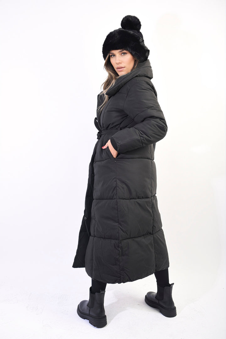 Woman wearing Longline Puffer Jacket with Belt Detail, showcasing its stylish longline cut and waist-cinching belt, perfect for winter warmth and fashion.