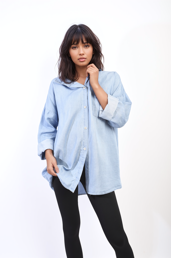 Woman wearing the Ivy Collared Button Down Long Sleeve Loose Top with Front Pocket, showcasing its relaxed fit and sophisticated collar.