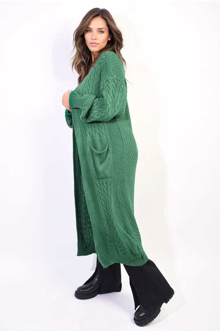 Woman in a long green Front Open Long Knitted Cardigan with front pockets, showcasing a casual and stylish look, perfect for everyday wear.