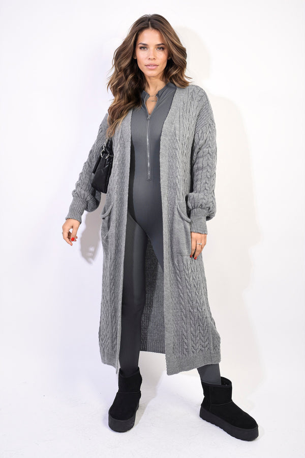 Woman wearing Front Open Long Knitted Cardigan with Front Pockets, styled with black boots and purse, showcasing cozy everyday fashion from Holiday Clothes UK.