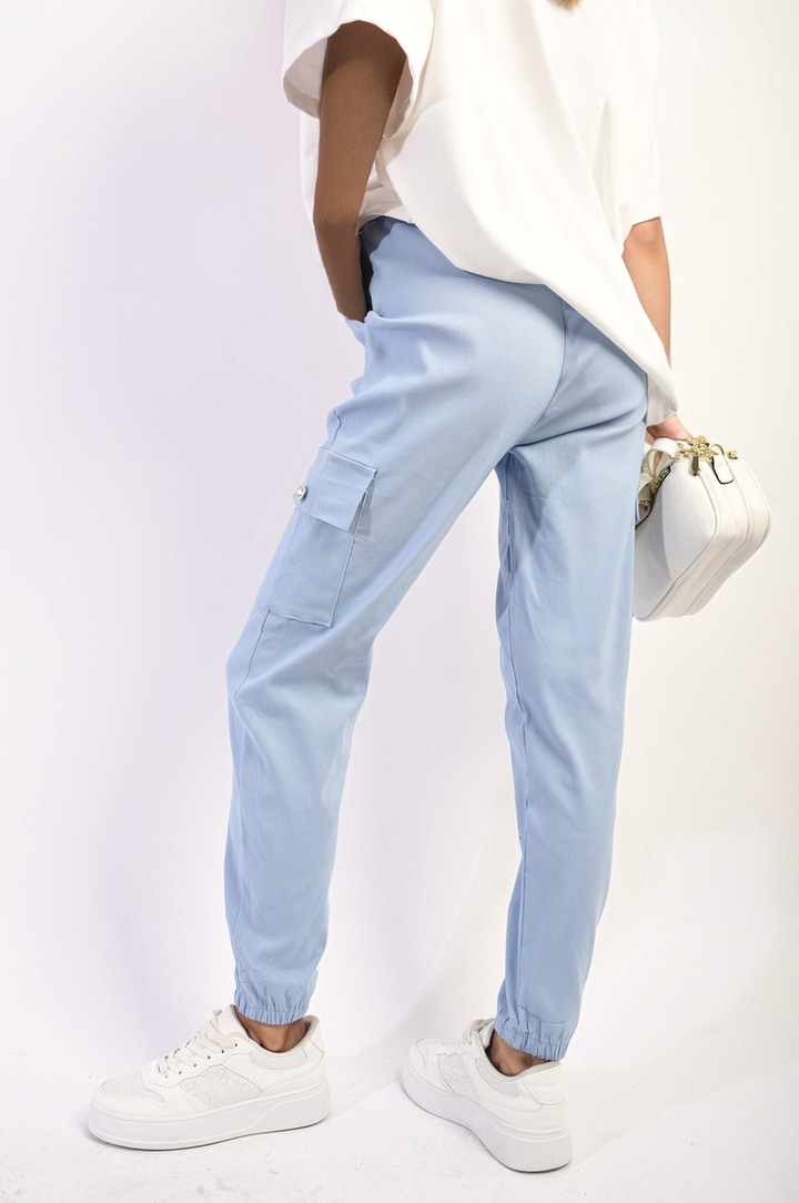 Woman wearing Janelle Drawstring Waist Cargo Joggers with white shoes, showcasing the joggers’ cargo pockets and elasticated cuffs for a modern, stylish look.