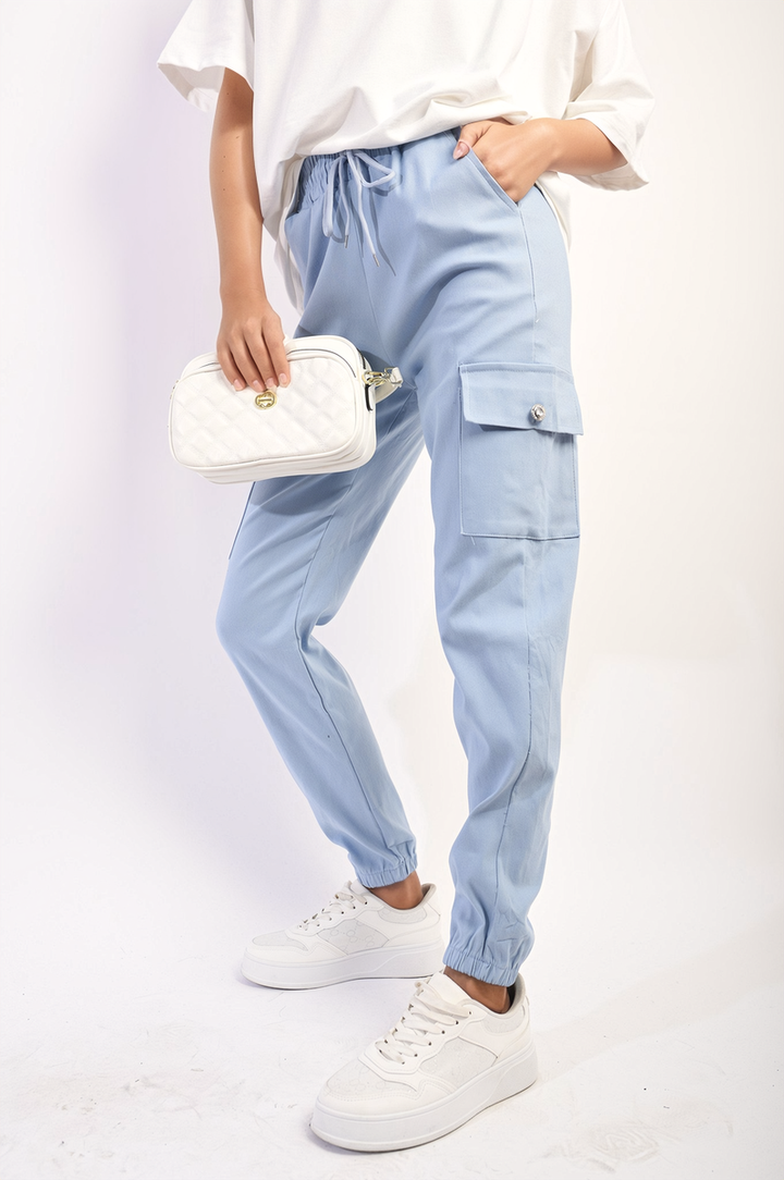 Person wearing Janelle Drawstring Waist Cargo Joggers with white sneakers, showcasing the joggers' stylish cargo pockets and drawstring waist for a comfortable fit.