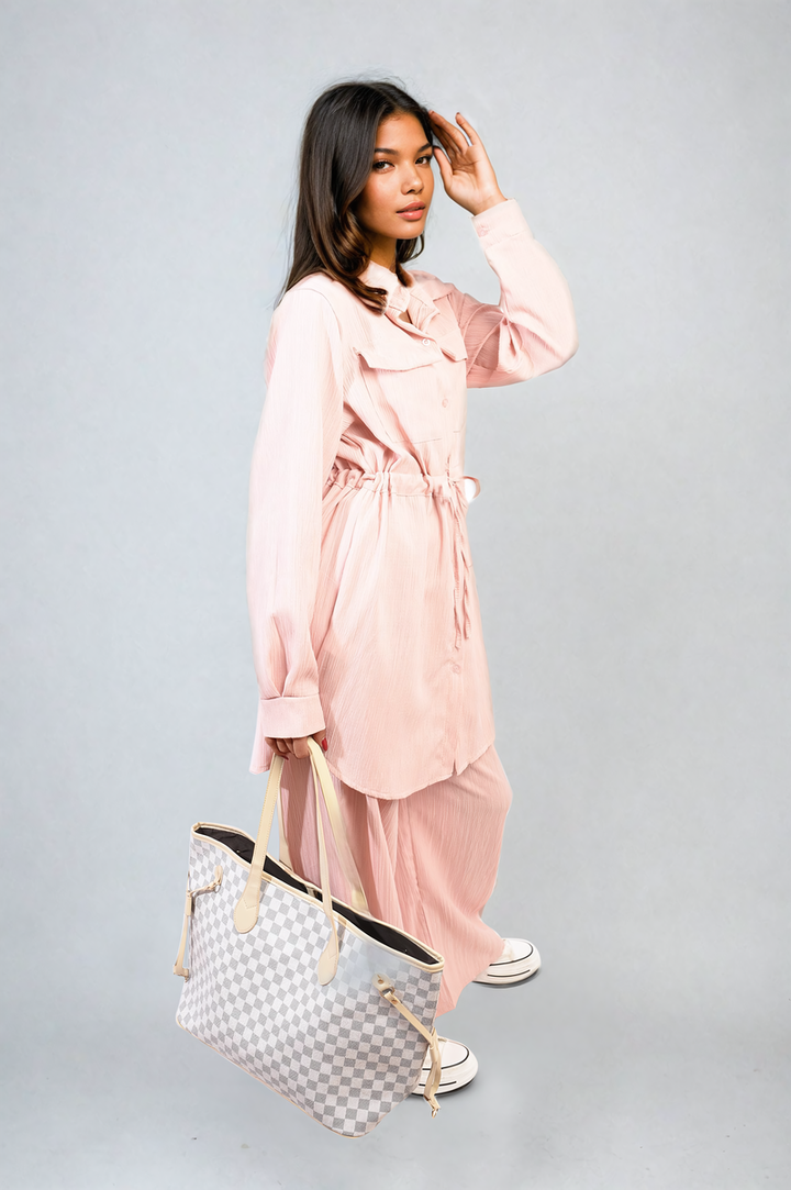 Woman wearing the Oversized Long Sleeve Belted Button Down Top and Trouser Co-ord Set, showcasing its comfortable, stylish fit with a belted waist.