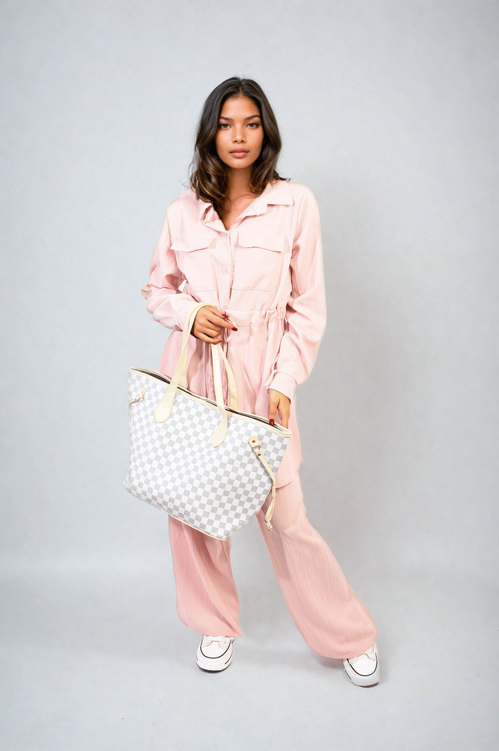 Woman in Oversized Long Sleeve Belted Button Down Top and Trouser Co-ord Set, holding a stylish handbag, showcasing fashionable holiday attire.