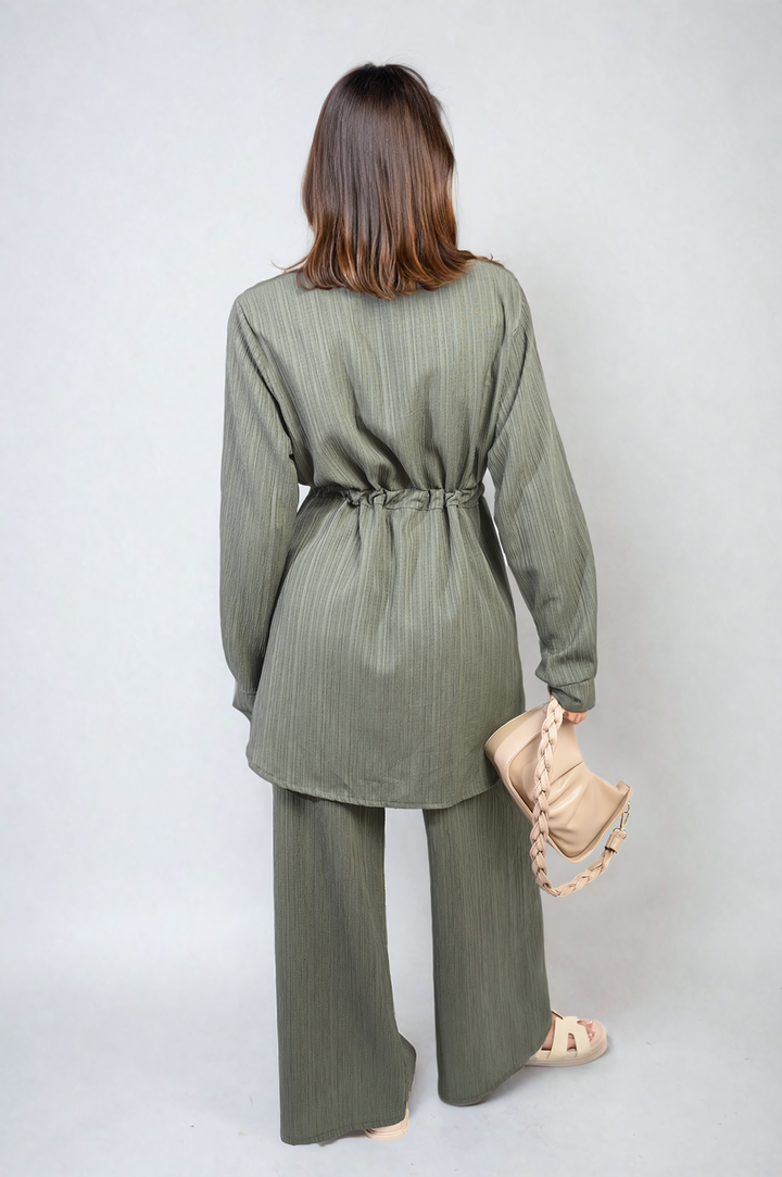 Woman wearing the Oversized Long Sleeve Belted Button Down Top and Trouser Co-ord Set, showcasing its stylish, oversized fit and modern wide-leg trousers.