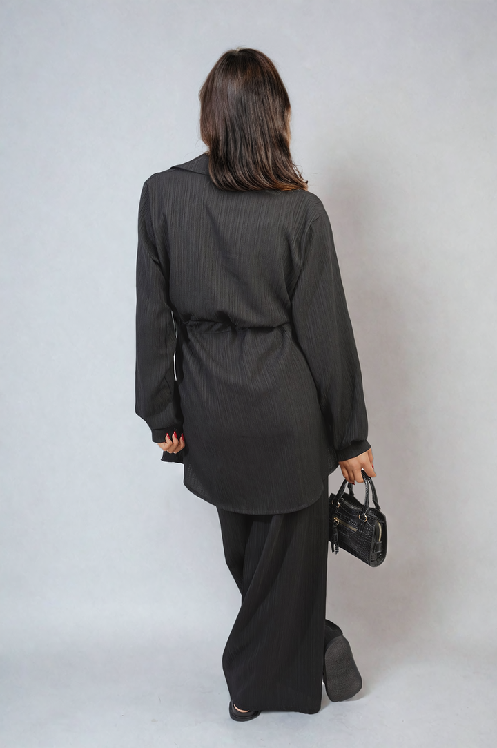 A woman models the Oversized Long Sleeve Belted Button Down Top and Trouser Co-ord Set, showcasing its sophisticated and versatile design.