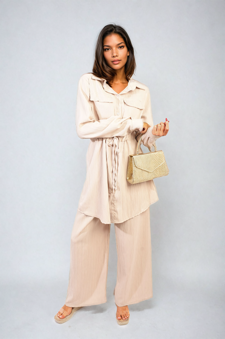 Woman wearing the Oversized Long Sleeve Belted Button Down Top and Trouser Co-ord Set, showcasing its relaxed fit and stylish design.