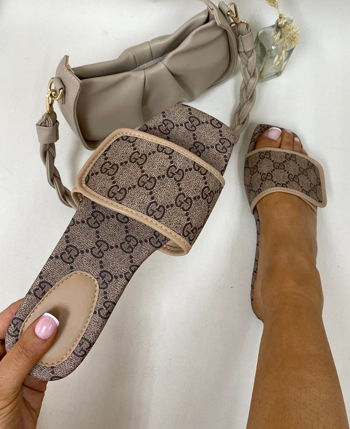 Patterned Front Strap Flat Sandals showcased with a person's legs, highlighting the trendy patterned front strap design and comfortable fit.