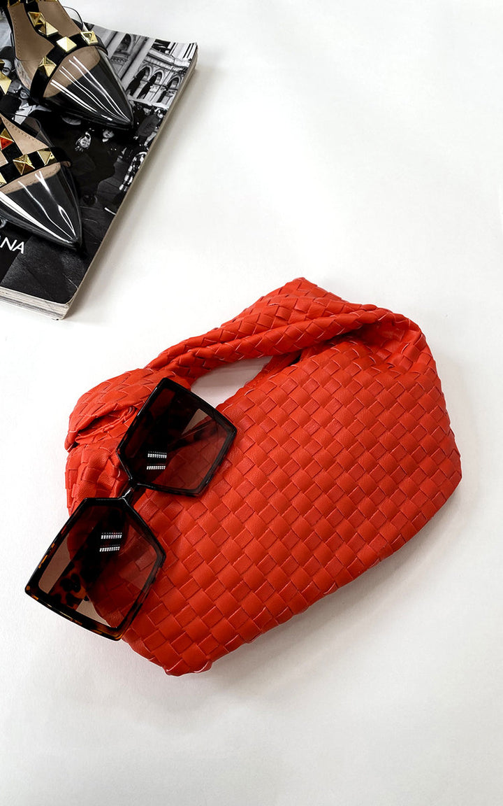 Faux Leather Quilted Handbag with sunglasses resting on top, showcasing its structured design and luxurious appeal, perfect for transitioning from day to night.