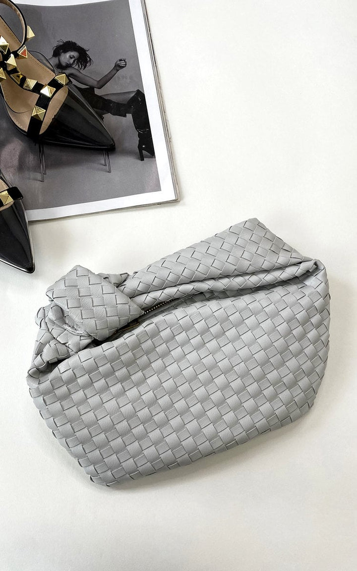 Faux Leather Quilted Handbag with structured design and quilted texture, ideal for day-to-night use, displayed on a white surface next to a magazine.