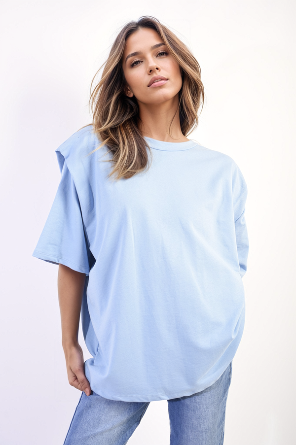 Woman wearing the Jeanette Oversized Top, showcasing its relaxed fit and stylish design, ideal for casual outings or lounging.