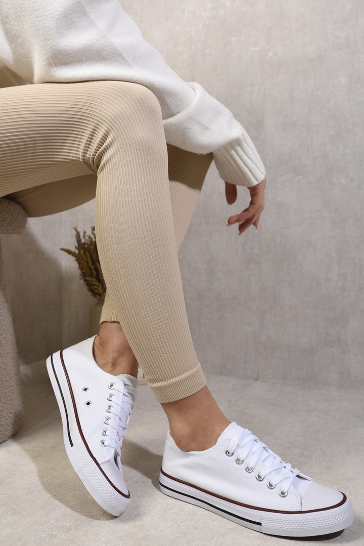 Person wearing Jenna Platform Low Top Lace Up Trainers, showcasing their chic design and comfort-focused features, perfect for stylish everyday wear.