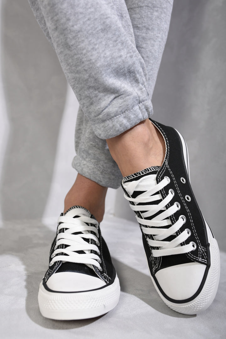 Platform Low Top Lace Up Trainers on person, showcasing comfortable design with platform sole and lace-up closure, perfect for stylish everyday wear.