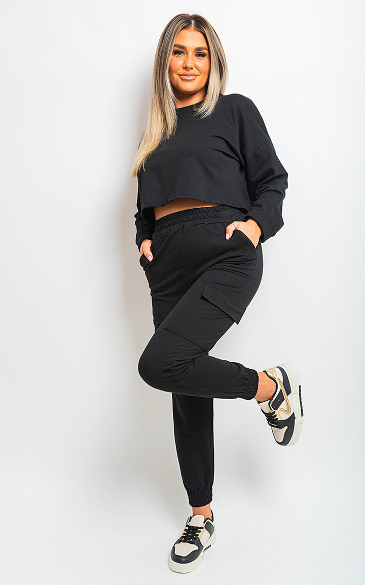 Woman in Jessie Cropped Long Sleeve Top and Cargo Joggers Co-ordinates, showcasing trendy street-style attire with modern cropped design and functional cargo pockets.