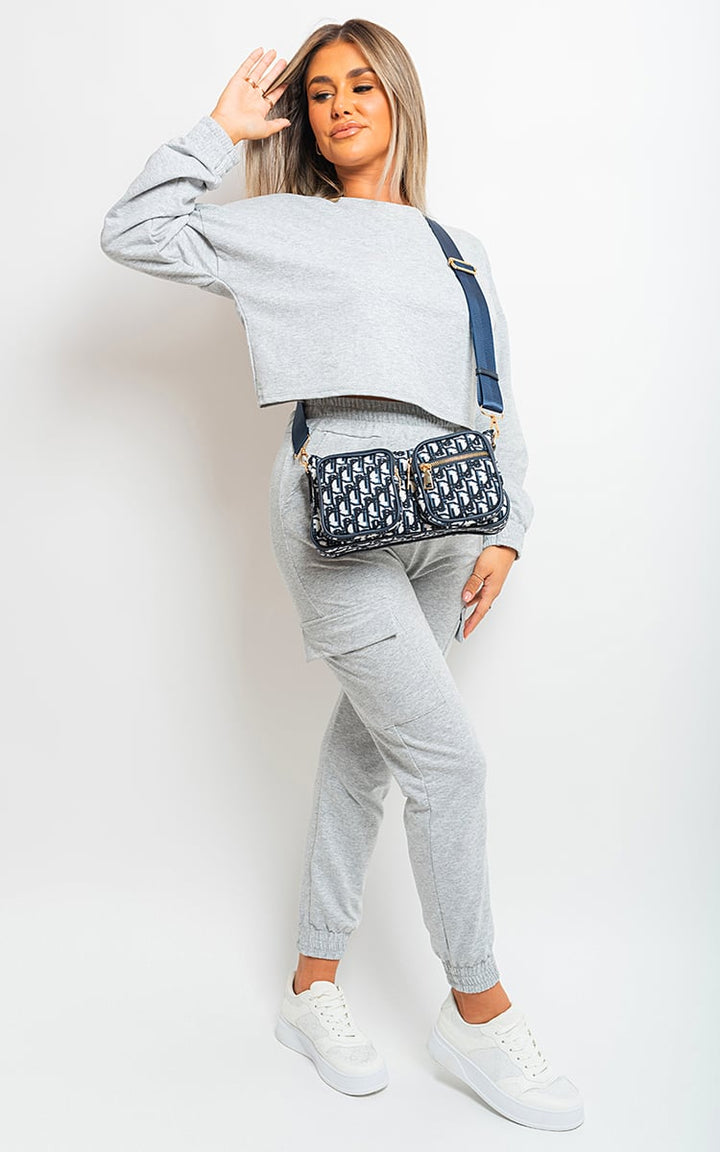 Woman wearing the Jessie Cropped Long Sleeve Top and Cargo Joggers, showcasing a casual street-style look with a blue purse and white shoes.