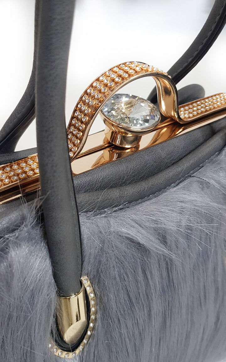 Faux Fur Handbag with faux fur front and faux leather back, featuring gold diamante clip fastening. Ideal for pairing with winter coats for everyday elegance.