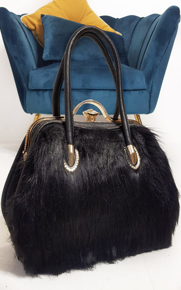 Faux Fur Handbag with gold diamante clip and leather straps, combining faux fur and leather materials, perfect for complementing winter outfits and everyday style.