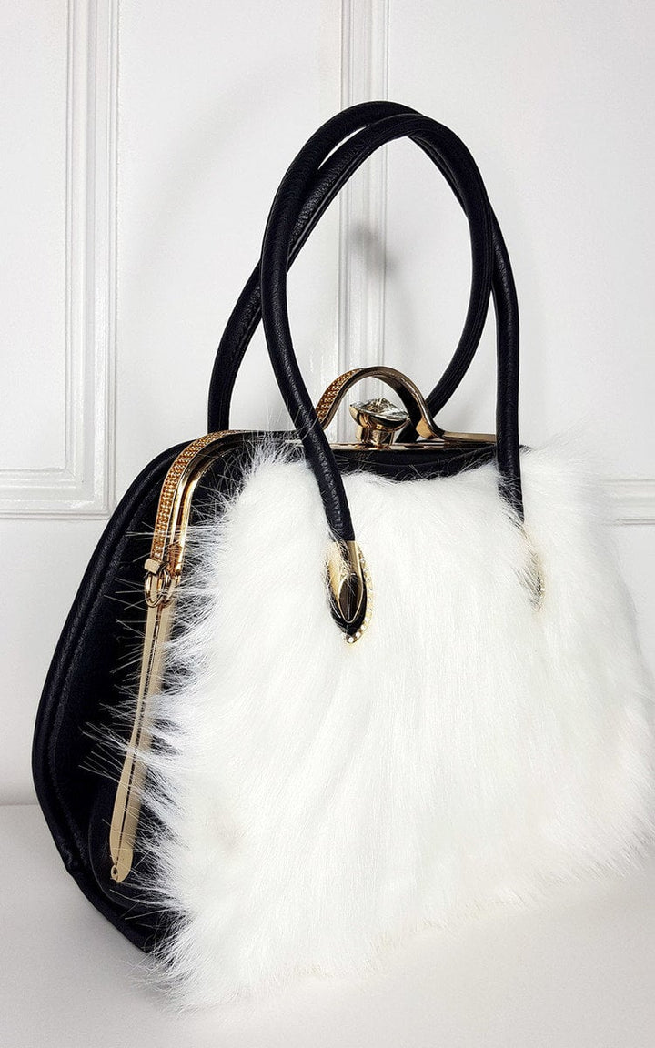 Faux Fur Handbag with black and white design, featuring gold diamante clip fastening and leather straps, ideal for pairing with winter coats.