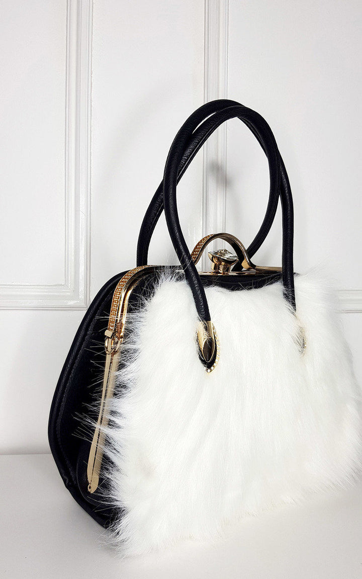 Faux Fur Handbag with black faux leather back, white faux fur front, and gold diamante clip fastening, ideal for pairing with winter coats.