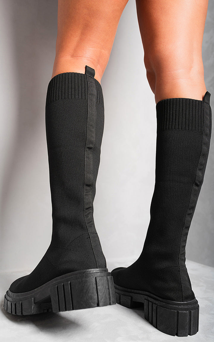 Knee High Chunky Sock Boots showcasing a sophisticated knee-high design and chunky heel, perfect for versatile styling and comfort.