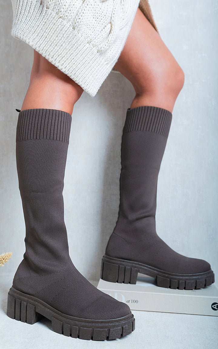 Jillian Knee High Chunky Sock Boots showcasing a chic, cozy sock-like design and chunky heel, perfect for versatile styling and comfortable wear.