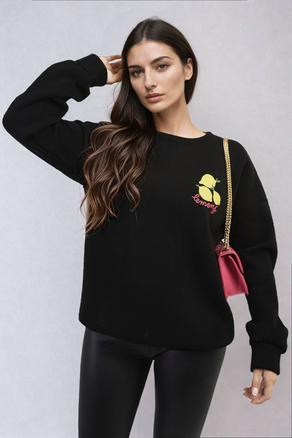 Woman wearing Joyce Lemon Graphic Long Sleeve Knitted Jumper, featuring a lemon design, perfect for a trendy, cozy look. Ideal for casual, stylish occasions.