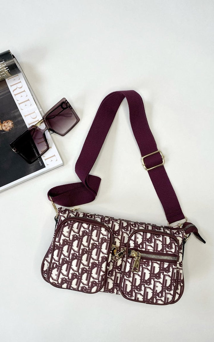 Julia Shoulder Handbag with sunglasses on a table, featuring adjustable strap and check print, ideal for elevating any outfit.