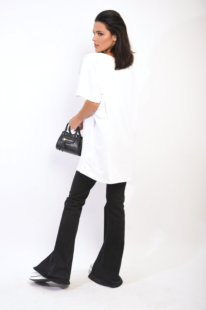 Woman holding a black purse, wearing the Juliana Embellished Neckline Short Sleeve Top, ideal for chic everyday style and layering.