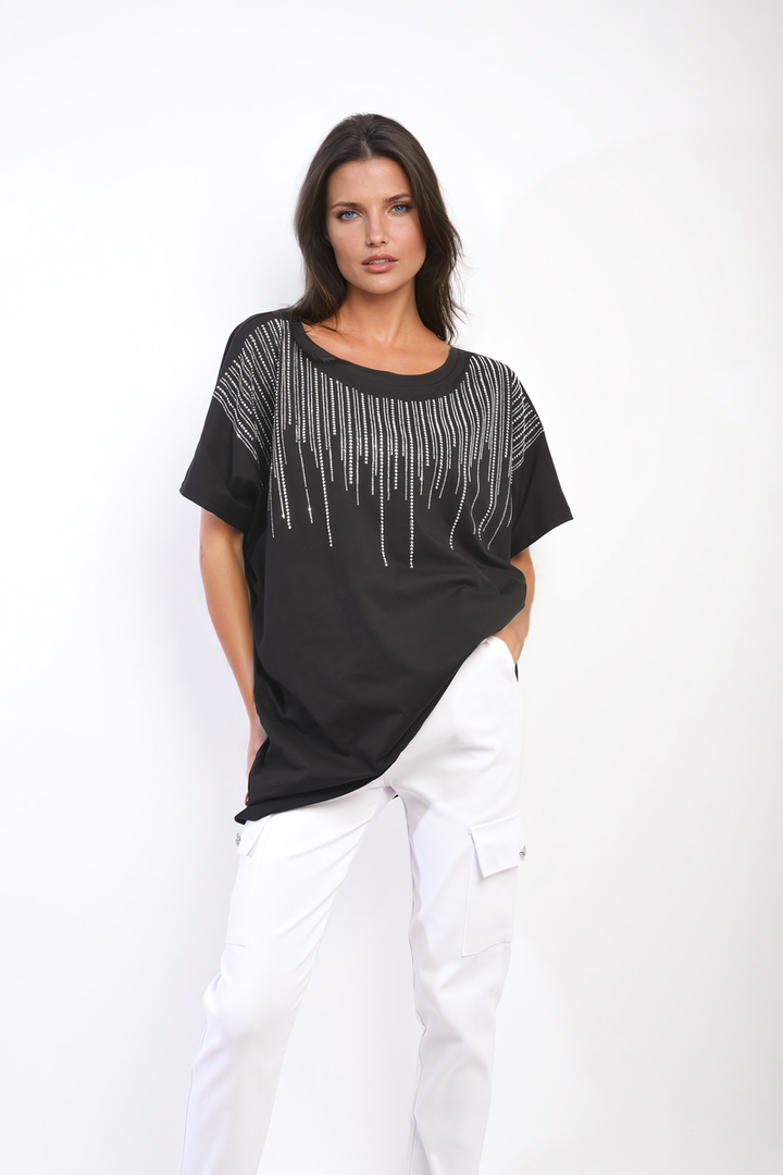 Woman wearing the Juliana Embellished Neckline Short Sleeve Top with white pants, showcasing a chic, stylish look for versatile everyday wear.