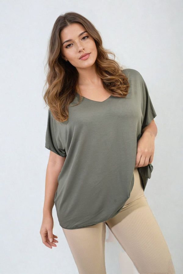 Woman modeling the Juliana Short Sleeve V-Neck Loose Top, showcasing its relaxed fit and breezy short sleeves, perfect for versatile styling and everyday comfort.