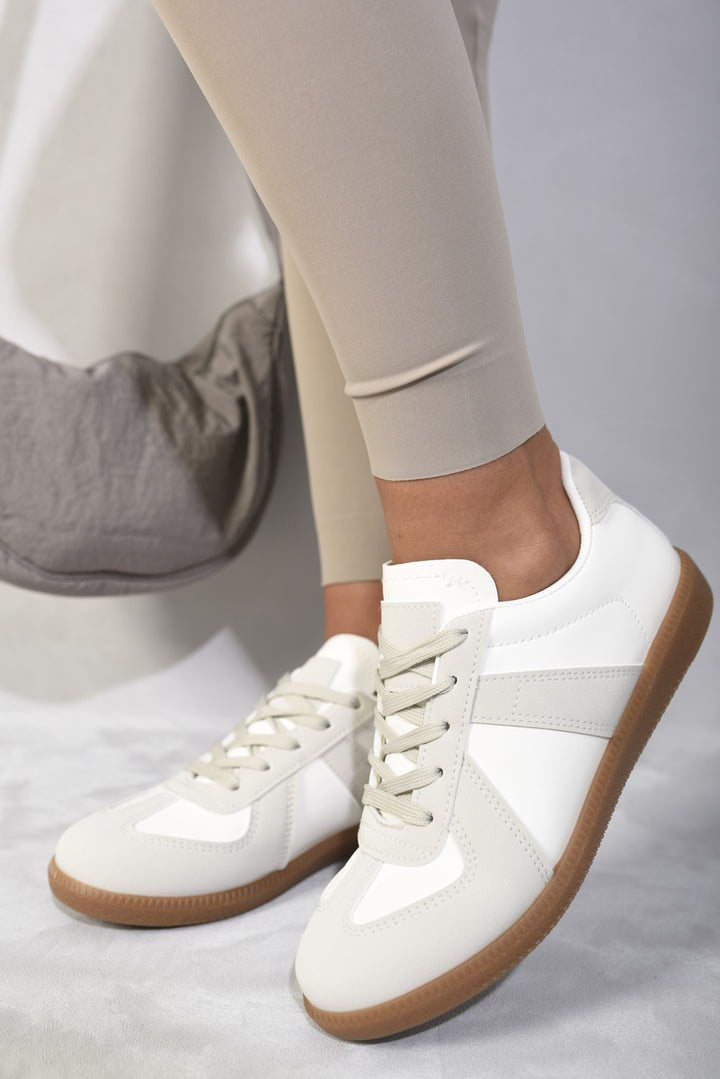 Low Top Lace-Up Trainers on a person's feet, showcasing their stylish and versatile design ideal for everyday casual wear.