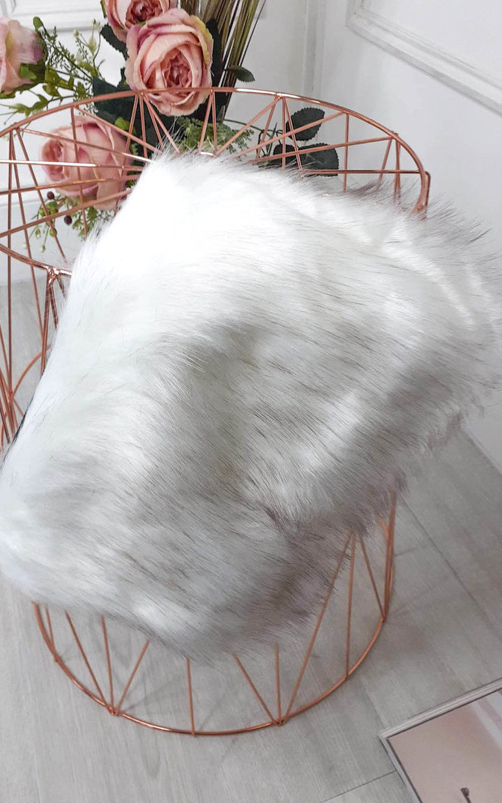 Faux Fur Shoulder Bag displayed in a copper wire basket, featuring a detachable silver chain strap and fluffy material, perfect for a chic daytime look.