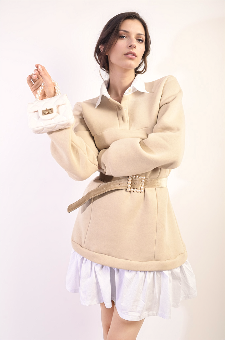 Woman showcasing the Collared Long Sleeve Mini Dress, featuring a stylish collar and long sleeves, paired with a white skirt and purse.