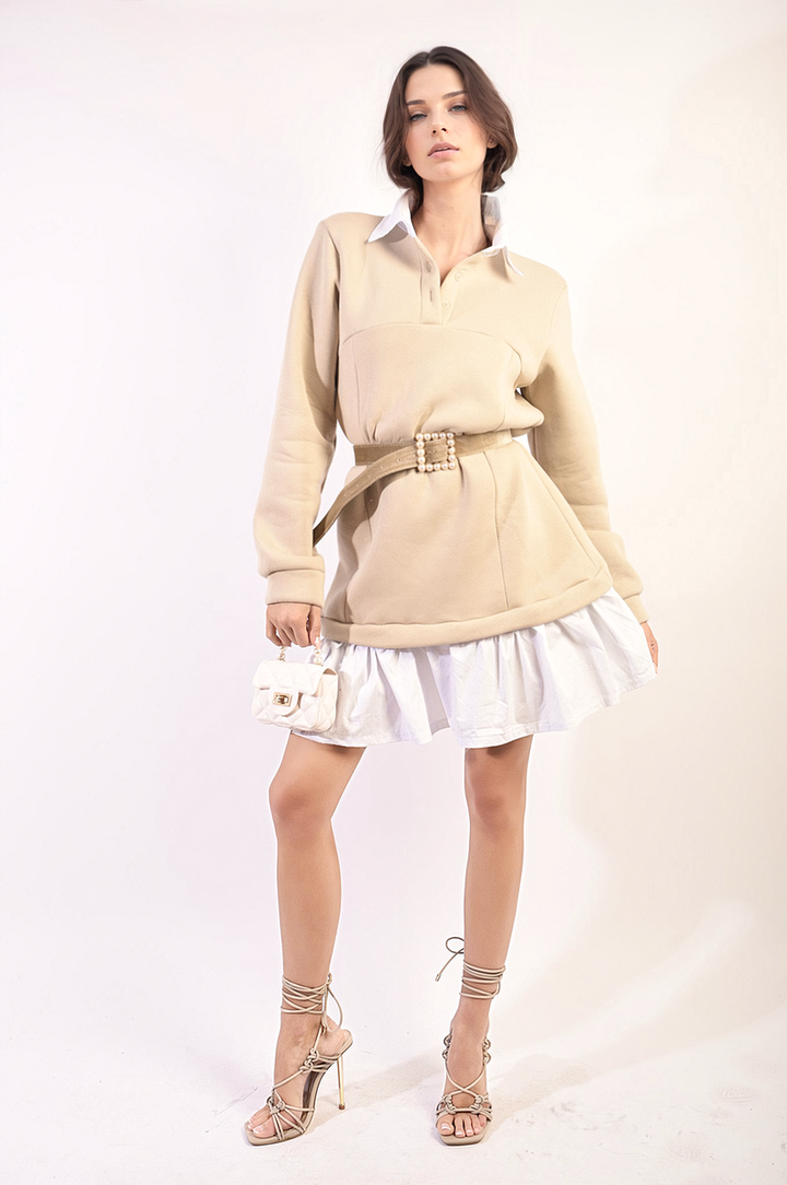 Woman in a Kayla Collared Long Sleeve Mini Dress, posing elegantly with a white purse, showcasing the dress's stylish design and comfortable fit.