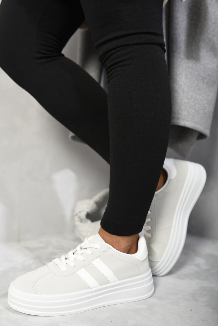 Person wearing Kaylee Lace Up Platform Trainers, showcasing stylish platform sole design ideal for everyday wear, enhancing height and fashion-forward appeal.