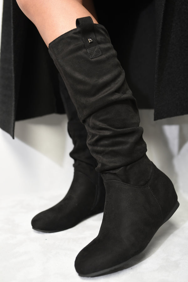 Person wearing Keilani Slouchy Zip Detail Knee High Boots with zip accents, showcasing casual elegance and modern style from Holiday Clothes UK.