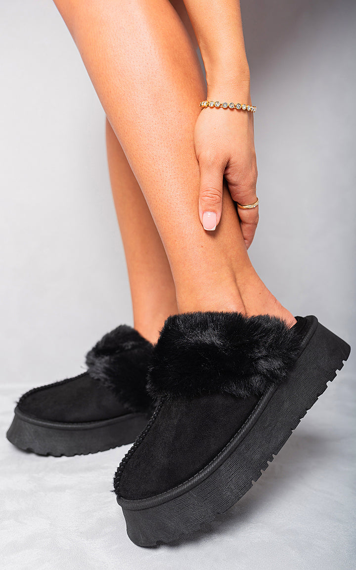 Faux Fur Trim Whisp Chunky Platform Slippers worn by a person, showcasing their chic faux fur trim and chunky platform design, perfect for stylish relaxation.