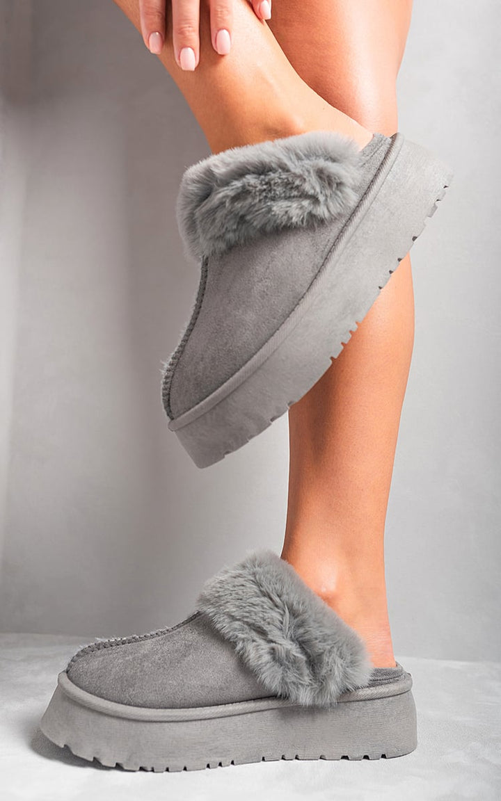 Person wearing Faux Fur Trim Whisp Chunky Platform Slippers, showcasing faux fur trim and chunky platform, ideal for stylish indoor comfort and relaxation.