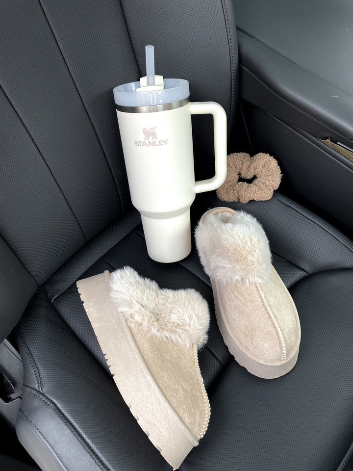 Faux Fur Trim Whisp Chunky Platform Slippers on car seat, featuring luxurious faux fur and chunky platform design for stylish comfort.