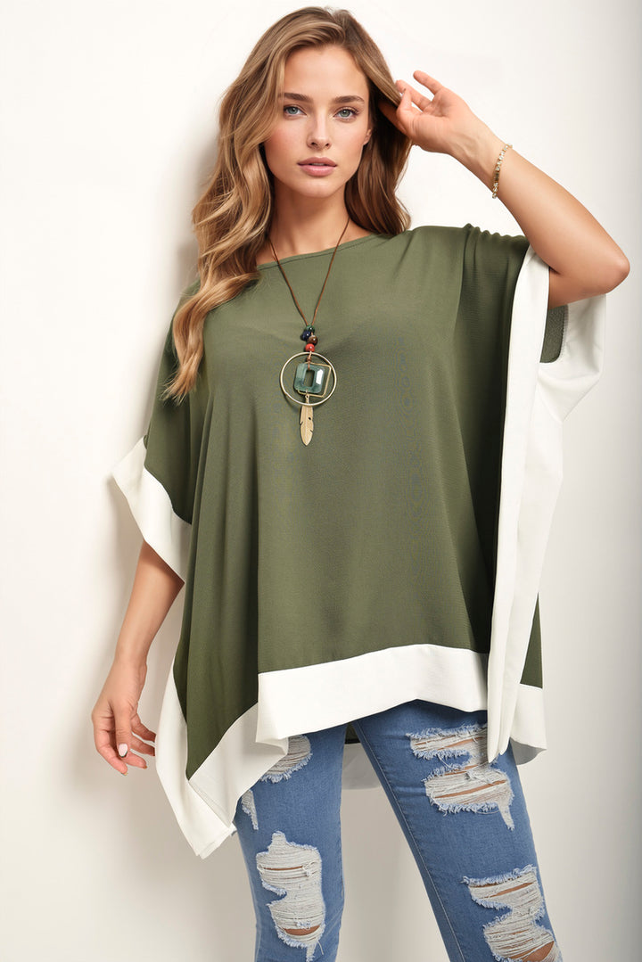 Woman wearing an Oversized Contrast Hem Flare Sleeve Top, showcasing its elegant flared sleeves and unique contrast hem detail.