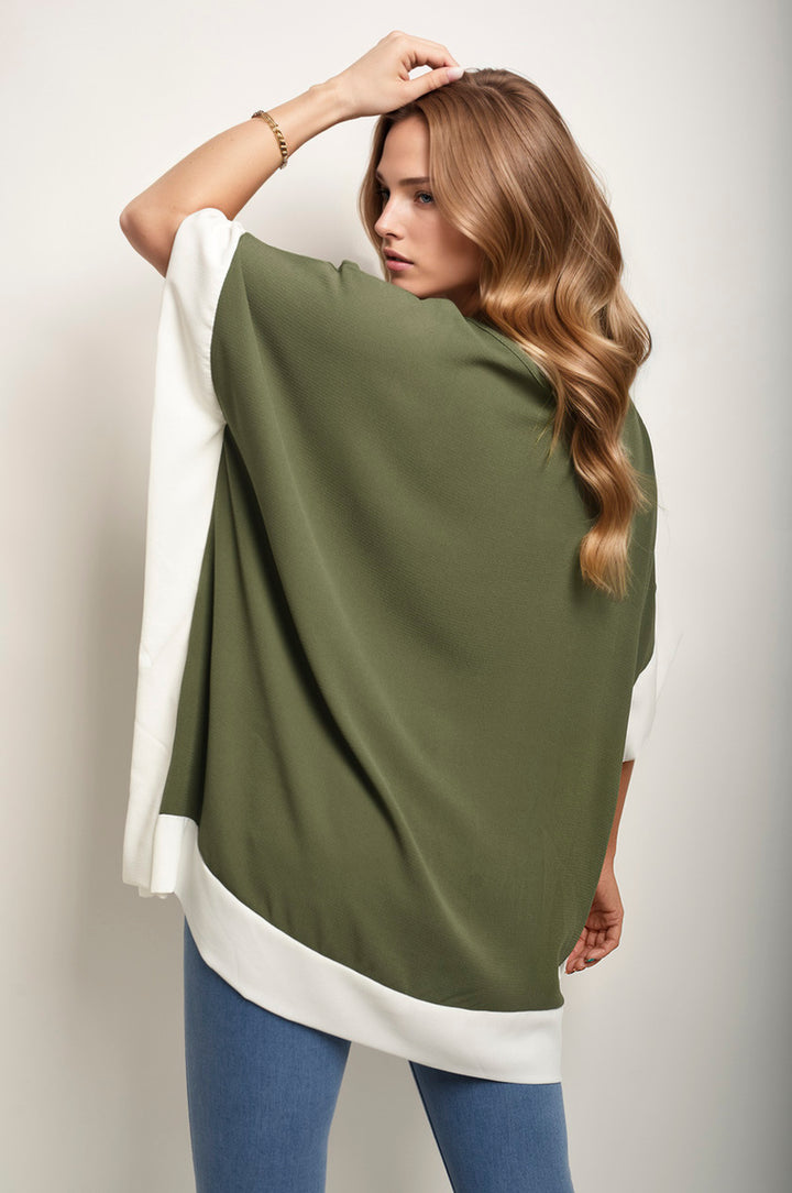 Woman wearing the Oversized Contrast Hem Flare Sleeve Top, showcasing its unique flared sleeves and relaxed fit, ideal for stylish, everyday wear.