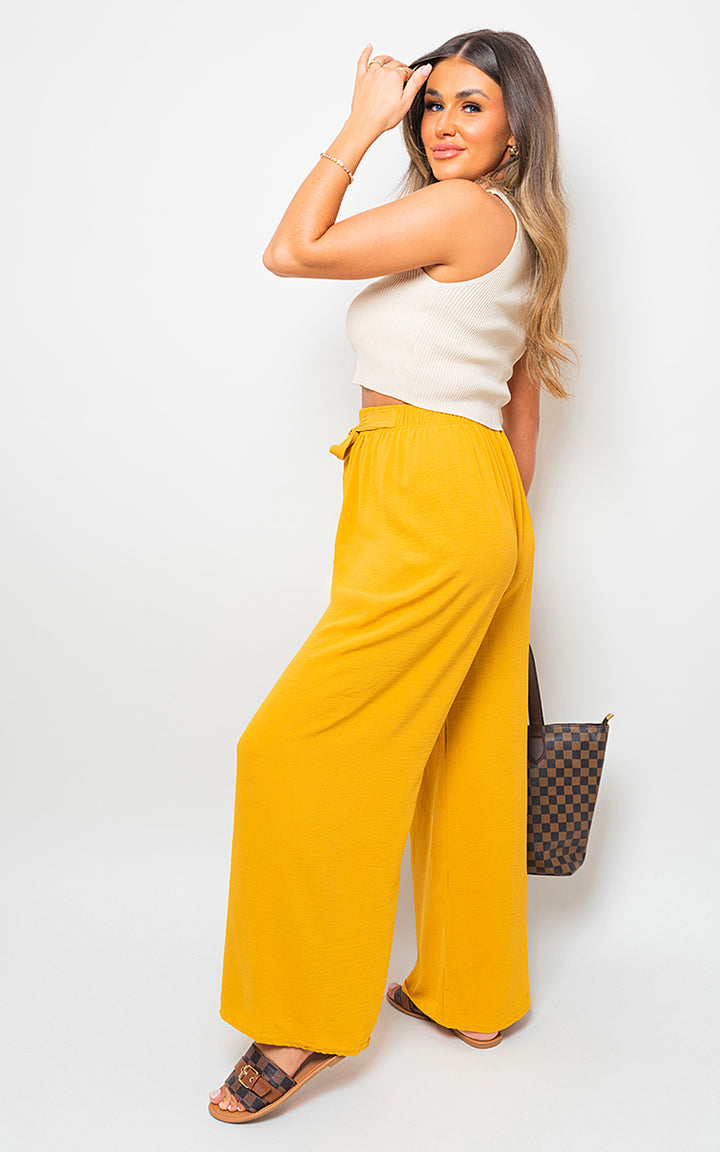 Woman wearing Lauryn Drawstring Waist Wide Leg Trouser, showcasing chic, comfortable design with customizable fit and wide-leg elegance, perfect for versatile styling.