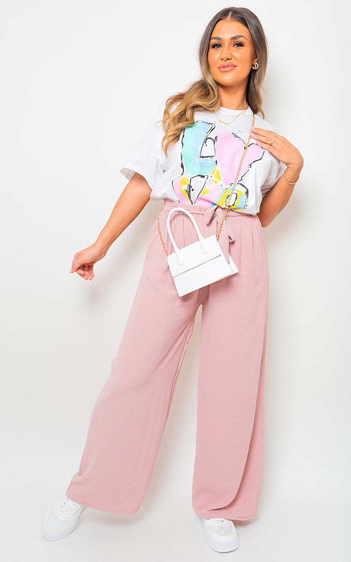 Woman wearing Lauryn Drawstring Waist Wide Leg Trousers, showcasing their chic, relaxed fit with a customizable waist and elegant wide-leg design.