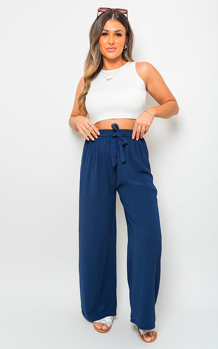 Drawstring Waist Wide Leg Trouser showcased on a woman, highlighting its chic, relaxed fit and drawstring waist for customizable comfort and style.