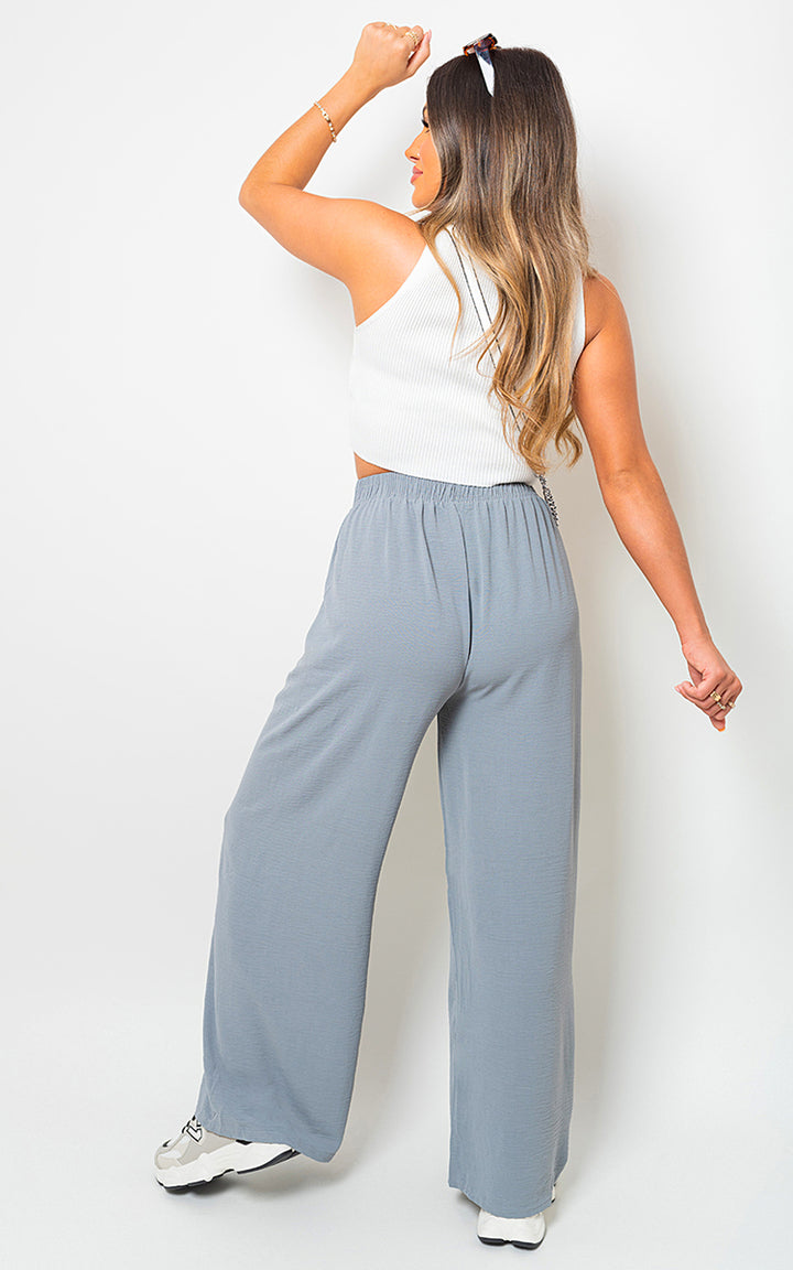 Woman wearing Lauryn Drawstring Waist Wide Leg Trousers, showcasing a relaxed, wide-leg fit and adjustable waist for chic comfort.