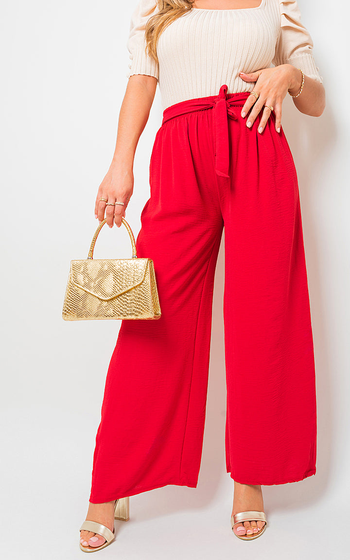 Woman modeling Drawstring Waist Wide Leg Trousers, holding a gold purse; showcases relaxed, chic style from Holiday Clothes UK's collection.